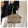 Close-up of khaki tote bag with winged design and fine buckle strap detail - Khaki