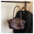 Close-up of a vintage dark brown leather tote bag featuring elegant side pleats and buckle - Reddish Brown