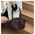 Detail of minimalist leather shoulder bag featuring pebble texture and metallic buckle - Gray