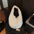 Creamy white corduroy hobo bag with vertical ribbed texture and spacious tote design - White