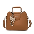 Brown litchi grain leather crossbody bag with a pearl bow pendant and metal chain handle - Biscuit