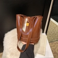 Deep brown leather bucket bag with gold clasp and shoulder strap for autumn fashion - Brown