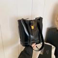 Glossy black leather bucket bag with gold hardware buckle and adjustable shoulder strap - Black