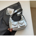 Detailed shot of silver metallic underarm bag with Y2K studs and dual front flap pockets - Silver