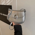 Minimalist silver saddle bag for women featuring a horseshoe metal lock and adjustable strap - Silver Without Pendant