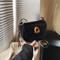 Minimalist black matte leather saddle bag with gold U-shaped hardware and woven pendant - Black With Pendant