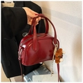 Retro burgundy bowling handbag with plush bear charm and metallic glossy leather finish - Red (With Charm)
