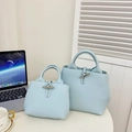 Light blue lychee pattern leather bucket bag with metal buckle closure in two sizes - Small / Blue