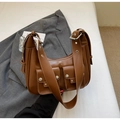 Brown faux leather underarm bag with silver studs and front pockets on a white blazer - Brown
