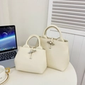 Chic beige leather bucket bags with signature bamboo clasp in two different sizes - Small / White