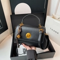 Minimalist black leather satchel with gold circular lock and woven charm in a gift box - Black