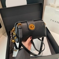 Retro black leather crossbody bag with golden clasp and decorative bell charm - Black