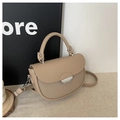 Beige patchwork saddle handbag with metallic buckle and shoulder strap in a 45-degree view - Khaki