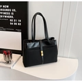 Minimalist black tote bag with matte texture, leather trim and gold metal clasp detail - Black