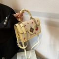 Cream crossbody handbag with red cherry print and golden flower clasp detail - Yellow