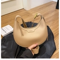 Detail view of beige lychee texture leather crescent bag with gold zipper and logo - Khaki