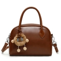Brown faux leather crossbody handbag with rounded handles and a cute plush bear charm - Tan