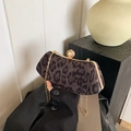 Elegant leopard print clutch bag with golden metal frame and large pearl clasp detail - Black