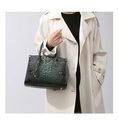 Detail of dark green crocodile texture leather tote bag with tassels and handles - Light Green