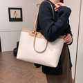 Retro cream tote bag with tan trim and textured leather shown on model's shoulder - Off White