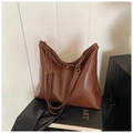 Close-up of brown hobo bag with gold chain strap and metal swivel lock detail - Brown
