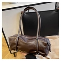 Detail of dark brown polished PU leather Boston bag with stitching and silver hardware - Brown
