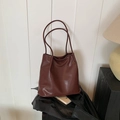 Elegant dark brown leather tote bag with slim shoulder straps and soft glossy texture - Red