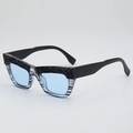 Vintage cat-eye sunglasses with blue lenses and textured black rock pattern frames - Blue Striped Frame