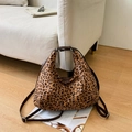 Dettaglio della borsa leopardata con tracolle marroni su pavimento in legno - Stampa Leopardata Scura