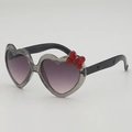 Kids heart-shaped sunglasses with silver glitter frames and a cute red bow decoration - Grey Frame Grey Lens