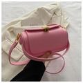 Pink minimalist box crossbody bag with a golden shell clasp on a white suit jacket - Pink