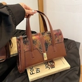 Detail of vintage brown textured leather handbag with colorful embossed floral pattern - Brown