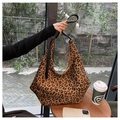 Primer plano del bolso hobo con estampado de leopardo y detalles de lona de alta calidad - Marrón