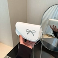 White lychee leather crossbody bag with silver bow ornament and metallic chain strap - White