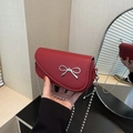 Red lychee pattern shoulder bag with silver bow accent and ball chain strap - Red