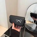 Elegant black lychee textured leather crossbody bag with silver bow and bead chain - Black