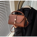 Brown leather crossbody bag featuring a vintage flap design and golden metal lock - Brown