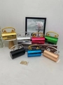 Detailed display of metallic lion-head cylindrical evening bags in seven vibrant colors - Gold