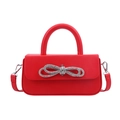 Red crossbody bag featuring a sparkling silver bow and elegant smooth leather finish - Red