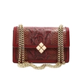 Red snakeskin textured crossbody bag with gold chain strap and elegant square metal clasp - Red
