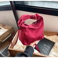 Detail of fuchsia nylon ruched bag with black metal hardware and removable crossbody strap - Red