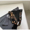 Chic black leather bucket bag with vibrant ethnic strap and brown bunny charm - Black (with Pendant)