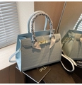 Detail of light blue croc-embossed handbag with gold clasp and floral silk scarf handle - Light Blue