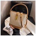 Woven straw bucket bag with leather trim and gold buckle for casual summer styling - Khaki