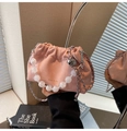 Close-up of pink pleated cloud bag featuring silver chain and translucent beaded handle - Pink