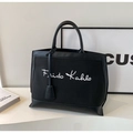 Black canvas and leather tote bag featuring white Frida Kahlo script with sturdy dual handles - Black