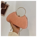Close-up of pink glitter evening bag featuring gold ring handle and metal chain strap - Champagne