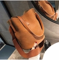 Minimalist tan bucket bag with matte finish and wide woven shoulder strap in a stylish set - Brown