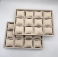 Macro view of two 12-slot beige velvet watch display trays with removable soft pillows - 12 Slots Beige Velvet
