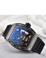 Macro view of tonneau watch case featuring a gold skull motif and skeleton dial detail - Black